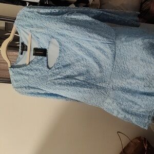 Beautiful light blue lace peplum blouse with cut out detail on chest.